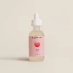 Minimalist bottle of Plant of Life THC-Free Organic CBD Oil with a pink gradient label, dropper cap, and neutral background